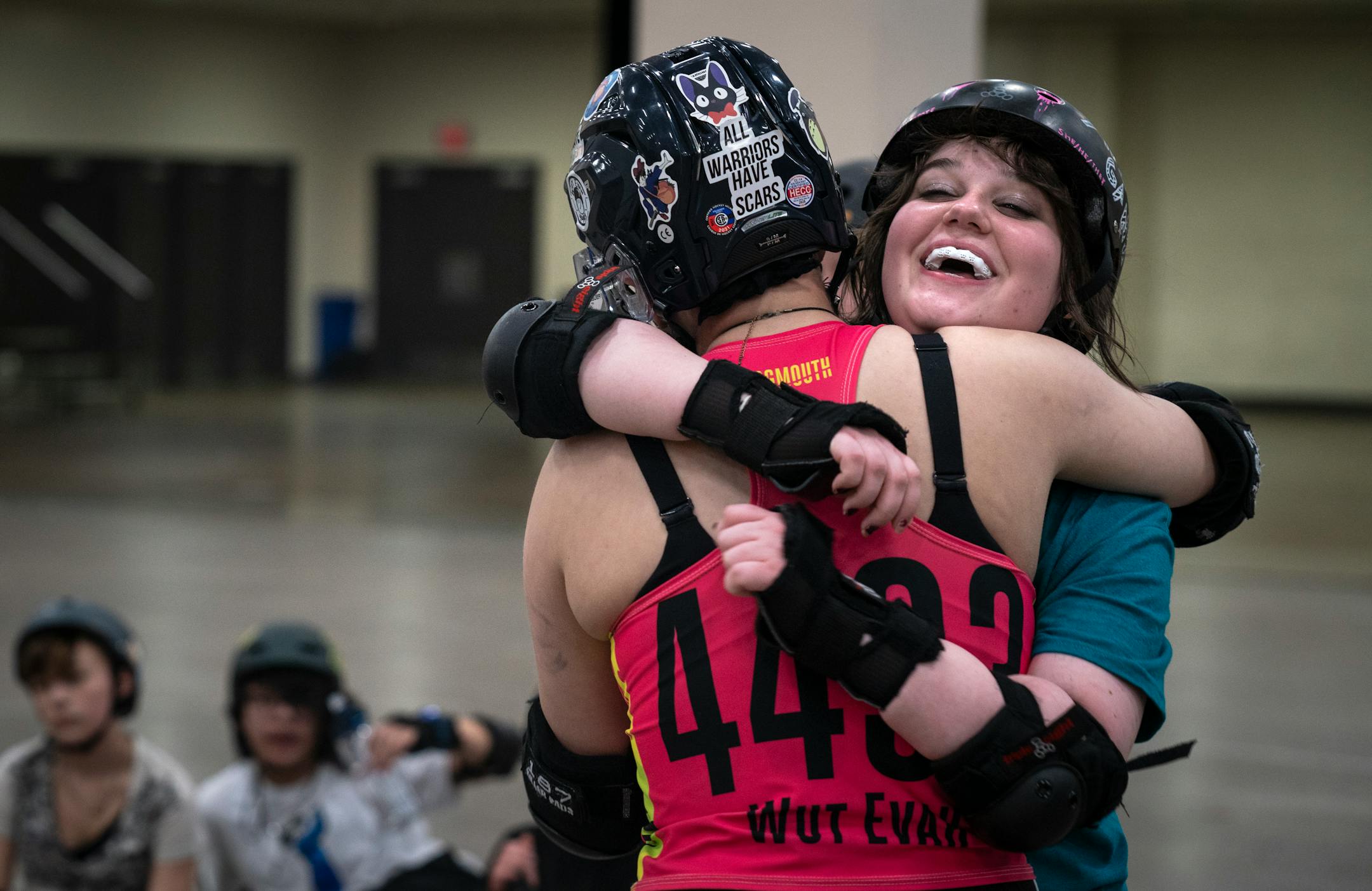 Axl-Lenore, derby name "Roddy Spike" hugs Eve Matson during practice in the Roy Wilkins Auditorium on Thursday, Nov. 9, 2023 in St. Paul, Minn. The four Minnesota Roller Derby teams will face each other Saturday, with Bodies of Water v.s. the Roller Vortex and the Maul Rats v.s. Wednesday Warnings ] Angelina Katsanis • angelina.katsanis@startribune.com