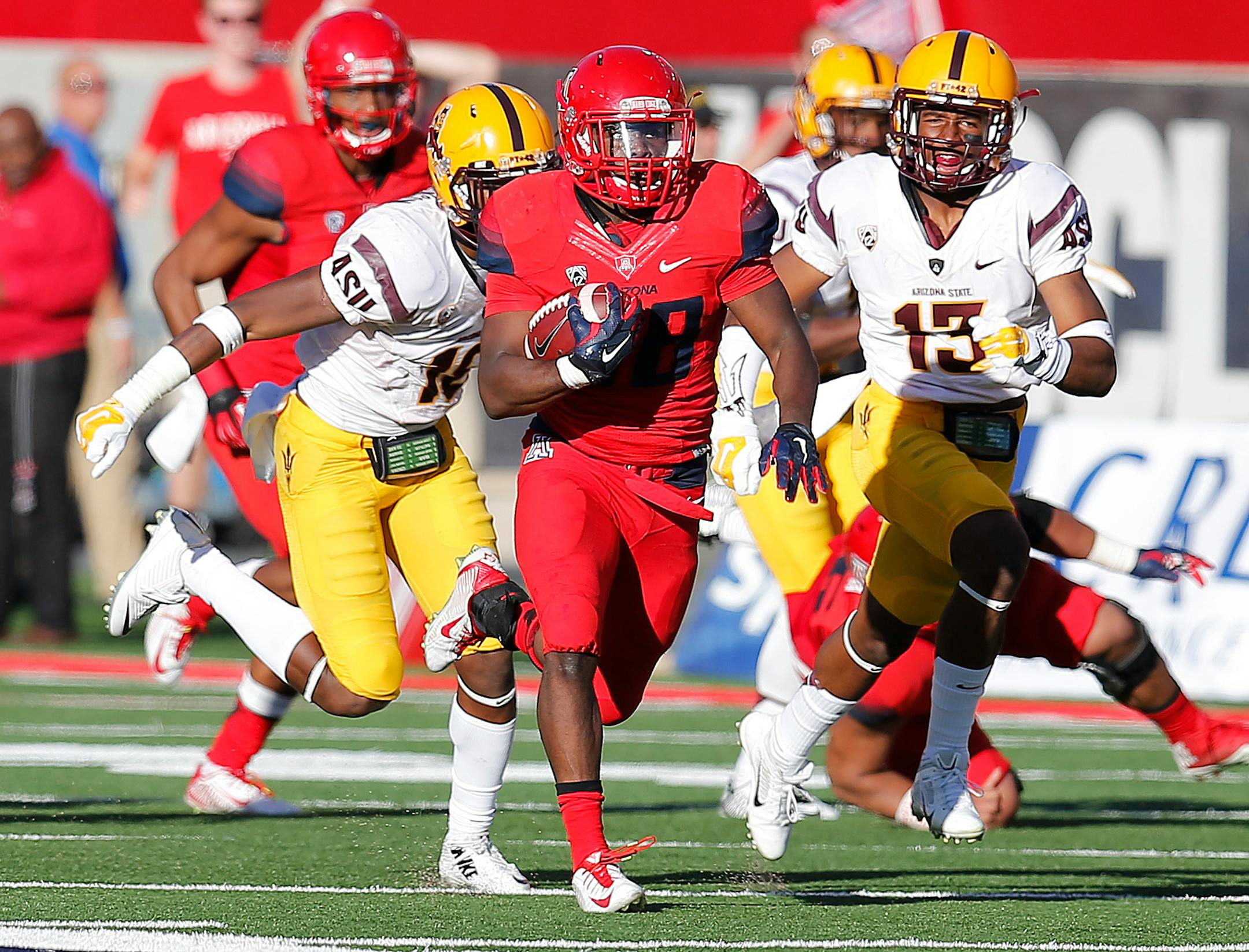 Arizona running back Nick Wilson (28) scores a touchdown during the second half of an NCAA college football game against Arizona State, Friday, Nov. 28, 2014, in Tucson, Ariz. (AP Photo/Rick Scuteri)