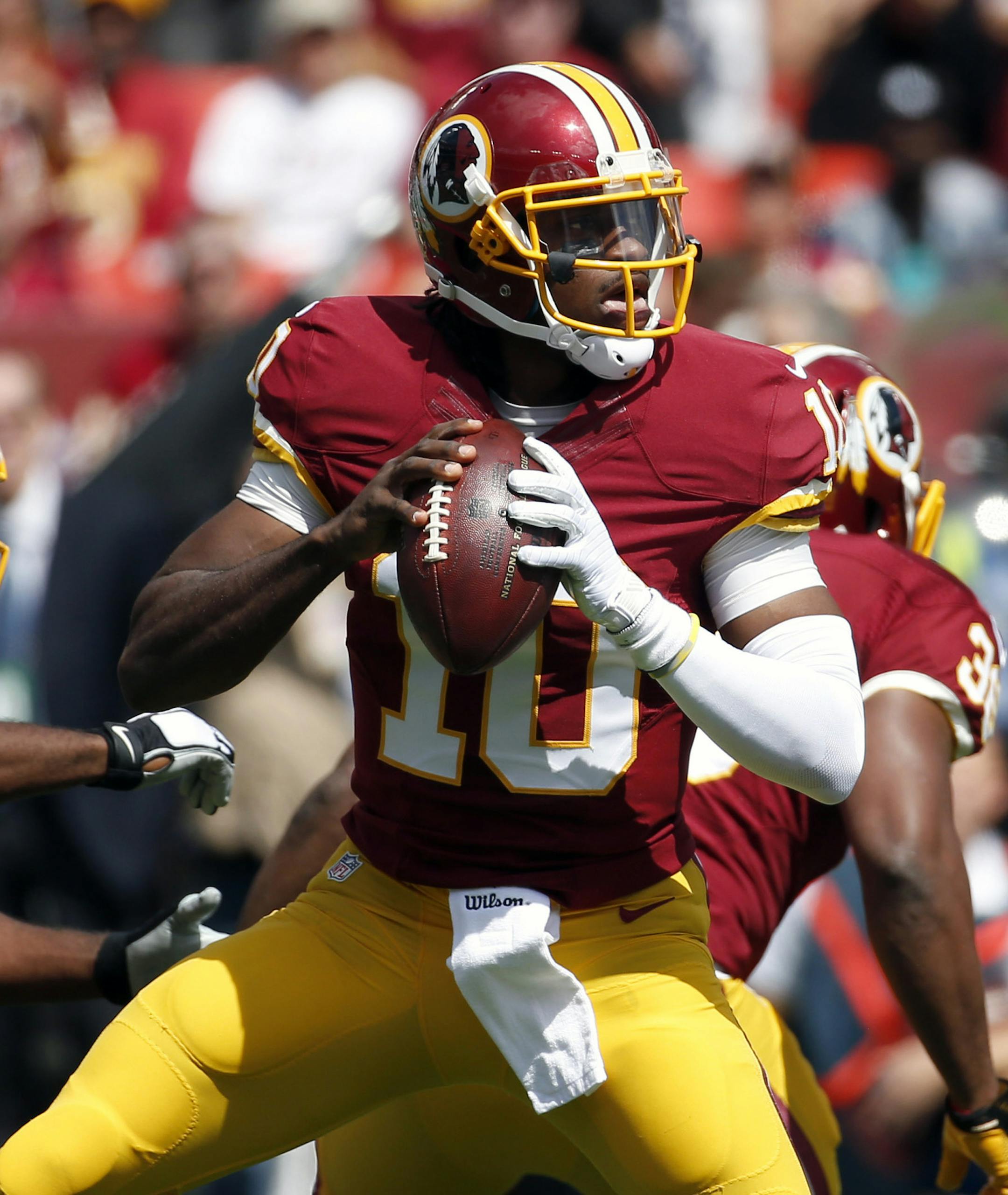 FILE - In this Sept. 14, 2014 file photo, Washington Redskins quarterback Robert Griffin III (10) looks to pass during the first half of an NFL football game against the Jacksonville Jaguars in Landover, Md. After six-plus games on the sideline, Robert Griffin III is back as the quarterback of the Washington Redskins for Sunday's, Nov. 2, 2014 game at Minnesota. (AP Photo/Alex Brandon, File)