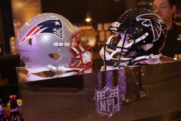 IMAGE DISTRIBUTED FOR NFL - New England Patriots and Atlanta Falcons football helmets are on display during the NFL Media Super Bowl party at Chapman 