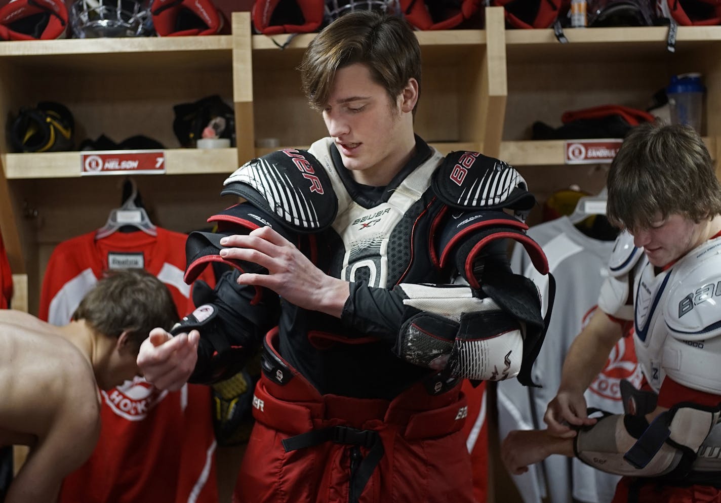 At the Blue Mound Ice Arena, the Luverne hockey team has built a strong following and culture in the region. (F) Chaz Smedsrud puts on his equipment with (D) Connor Sandbulte on the right.] rtsong-taatarii@startribune.com/ Richard Tsong-Taatarii