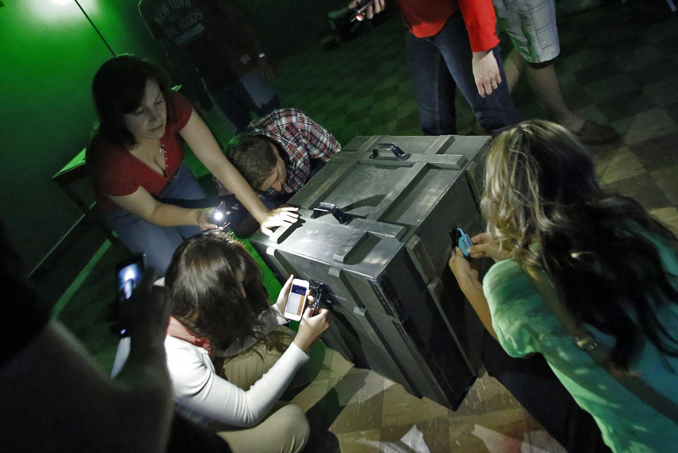 A group works on the various clues presented to them in an effort to find passage out of the riddle room.