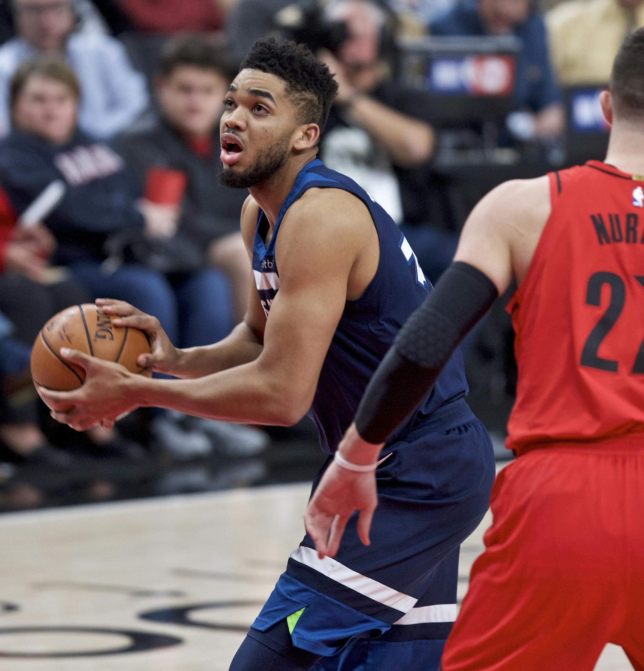 Minnesota Timberwolves center Karl-Anthony Towns, left, drives to the basket past Portland Trail Blazers center Jusuf Nurkic during the first half of an NBA basketball game in Portland, Ore., Thursday, March 1, 2018. (AP Photo/Craig Mitchelldyer)