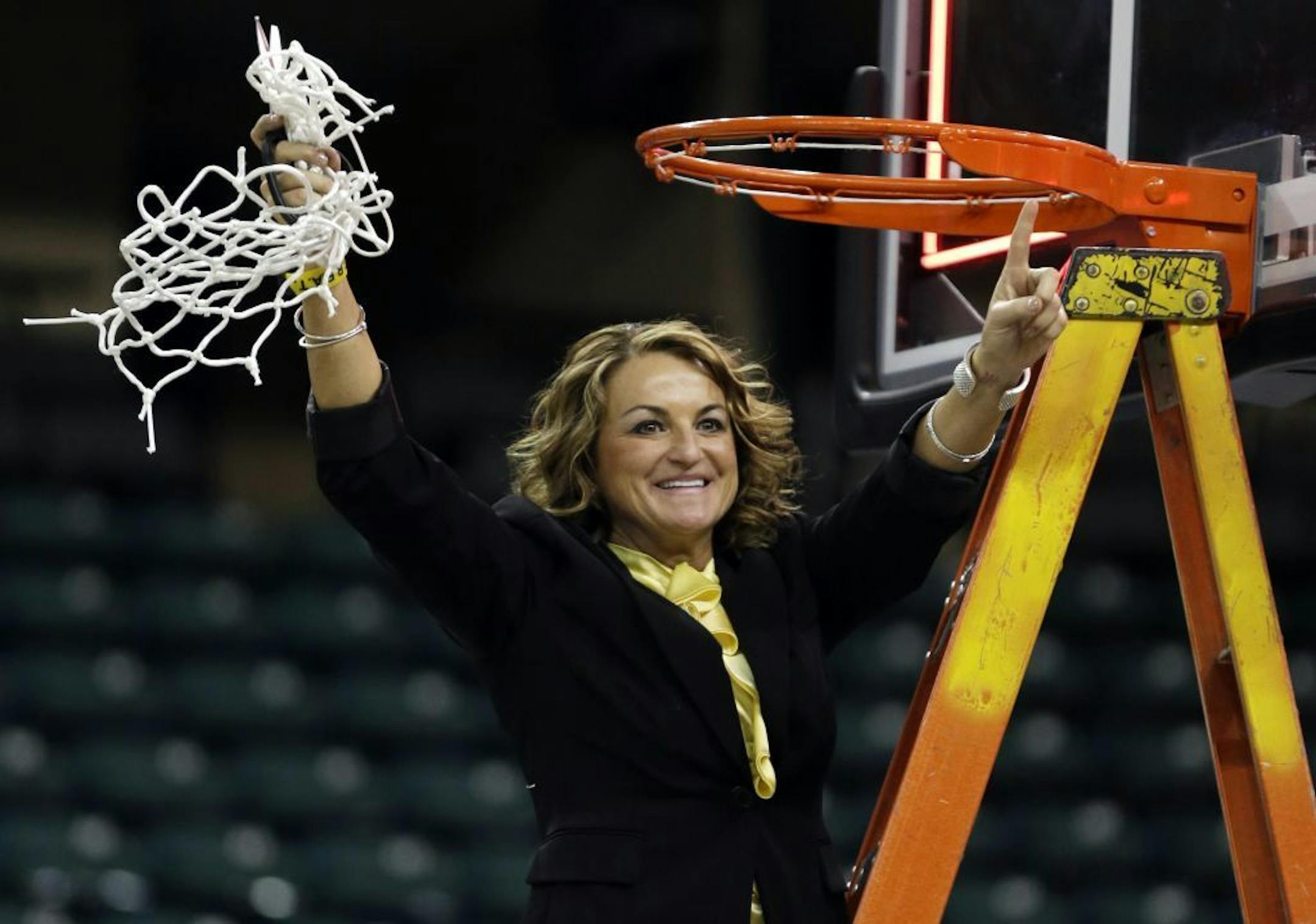 Wichita State head coach Jody Adams celebrates after the team's 73-49 victory over Drake during an NCAA college basketball game in the championship of the Missouri Valley Conference women's tournament Sunday, March 16, 2014, in St. Charles, Mo. Wichita State won 73-49.