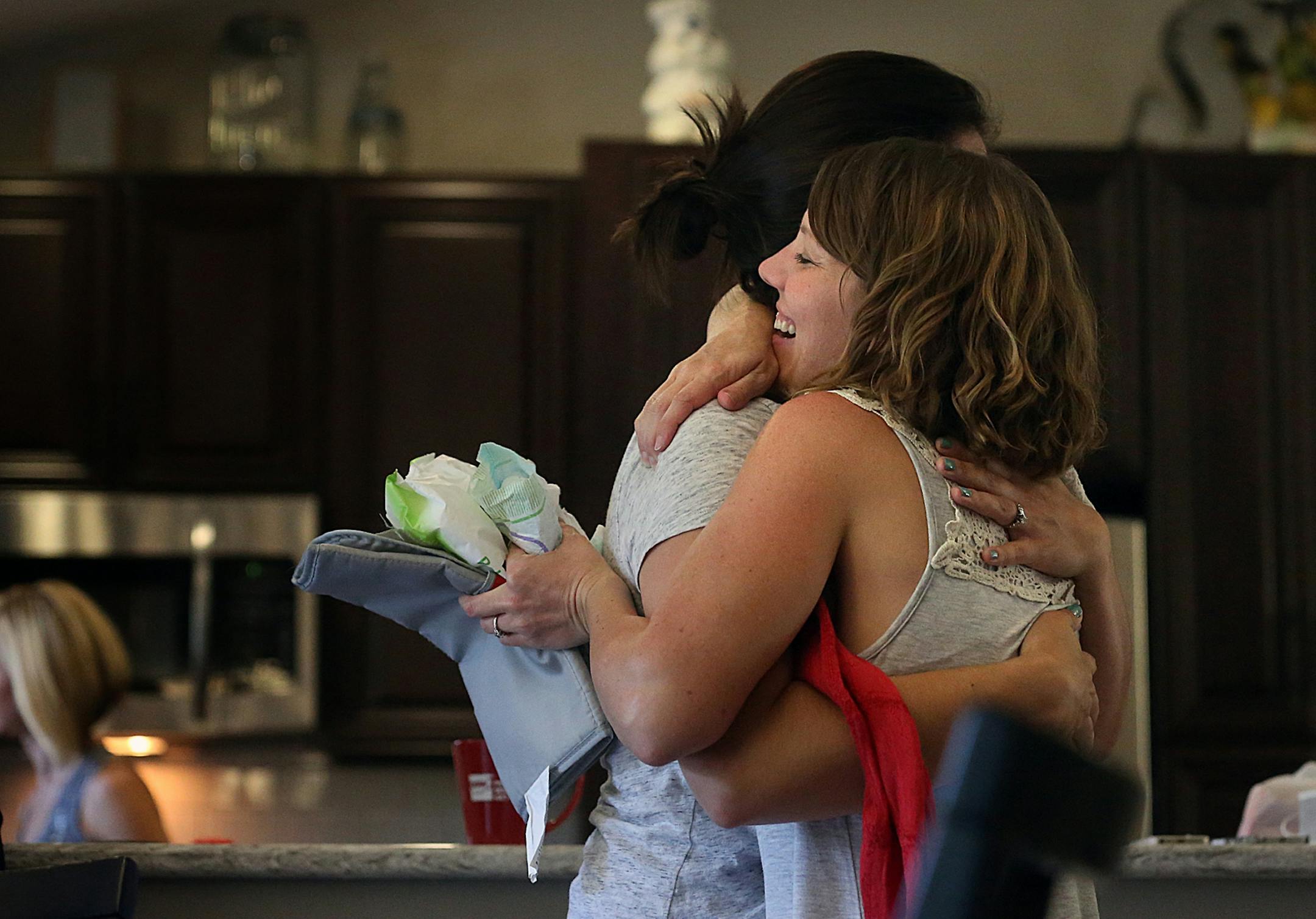 Friends Susan Sto (left) and Amy Korkki embraced.