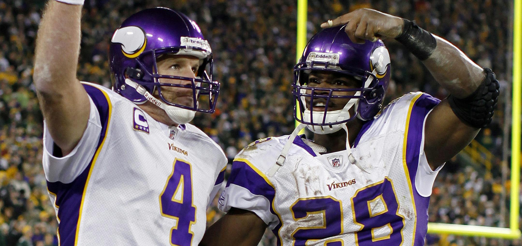 ** ADVANCE FOR WEEKEND EDITIONS, NOV. 7 -8 ** In this photo taken on Sunday, Nov. 1, 2009, Minnesota Vikings' Brett Favre (4) and Adrian Peterson (28) celebrate after Favre threw a touchdown pass against the Green Bay Packers during an NFL football game in Green Bay, Wis. The first half of Brett Favre's unfathomable season in Minnesota has been an unquestioned success, but how will the most important part go given Favre's fade down the stretch last year in New York? (AP Photo/Jeffrey Phelps) ORG