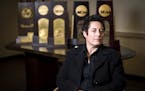 University of Minnesota Duluth womens' hockey head coach Shannon Miller is pictured in front of her five NCAA National Championship trophies in her of