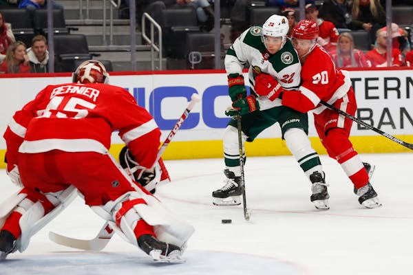Wild left wing Kevin Fiala tries to shoot on Red Wings goaltender Jonathan Bernier as Christoffer Ehn defends in the third period