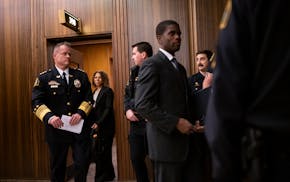 St. Paul Police Commander of Narcotics, Financial Intelligence and Human Trafficking Division Axel Henry and Mayor Melvin Carter emerge from Carter's