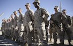 FILE - In this Jan. 15, 2018 file photo, U.S. Marines stand guard during the change of command ceremony at Task Force Southwest military field in Shor