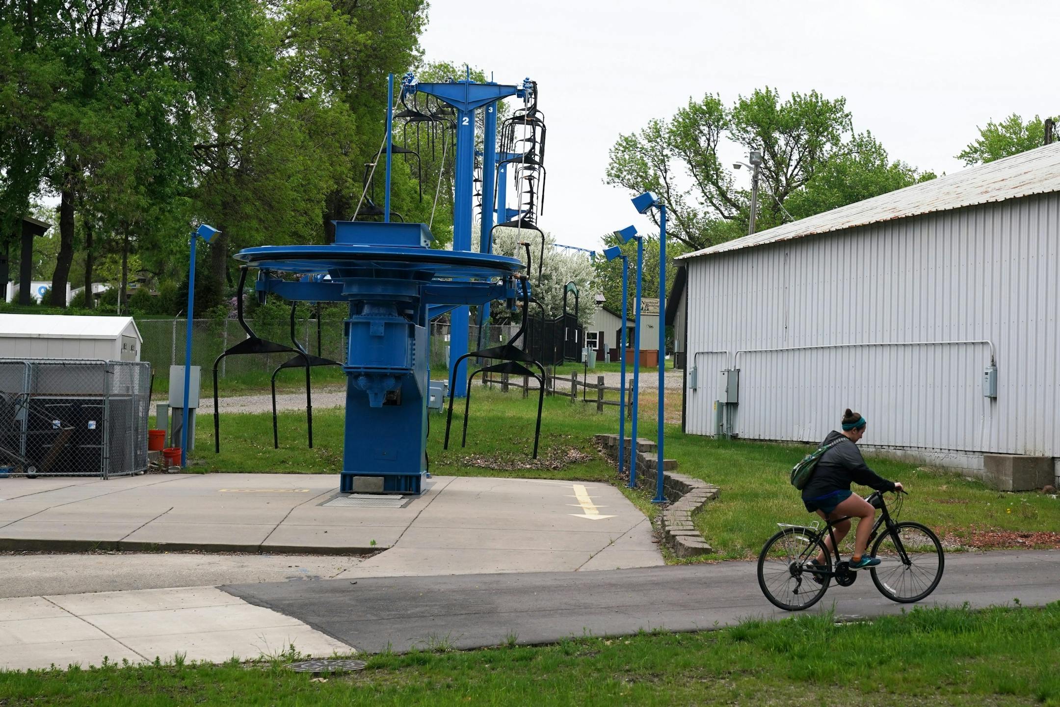A woman rode her bike past the Skyride Thursday.