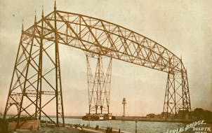 The first version of the Aerial Lift Bridge featured a gondola that transported passengers and vehicles.