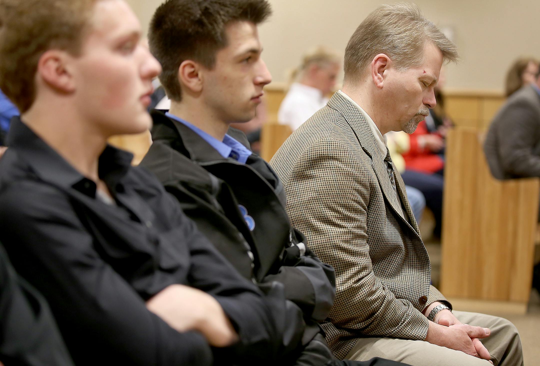 Levi Acre-Kendall's father Travis Kendall closed his eyes as the judge decided to go to trial during the hearing, Wednesday, April 22, 2015 in Balsam Lake, WI.