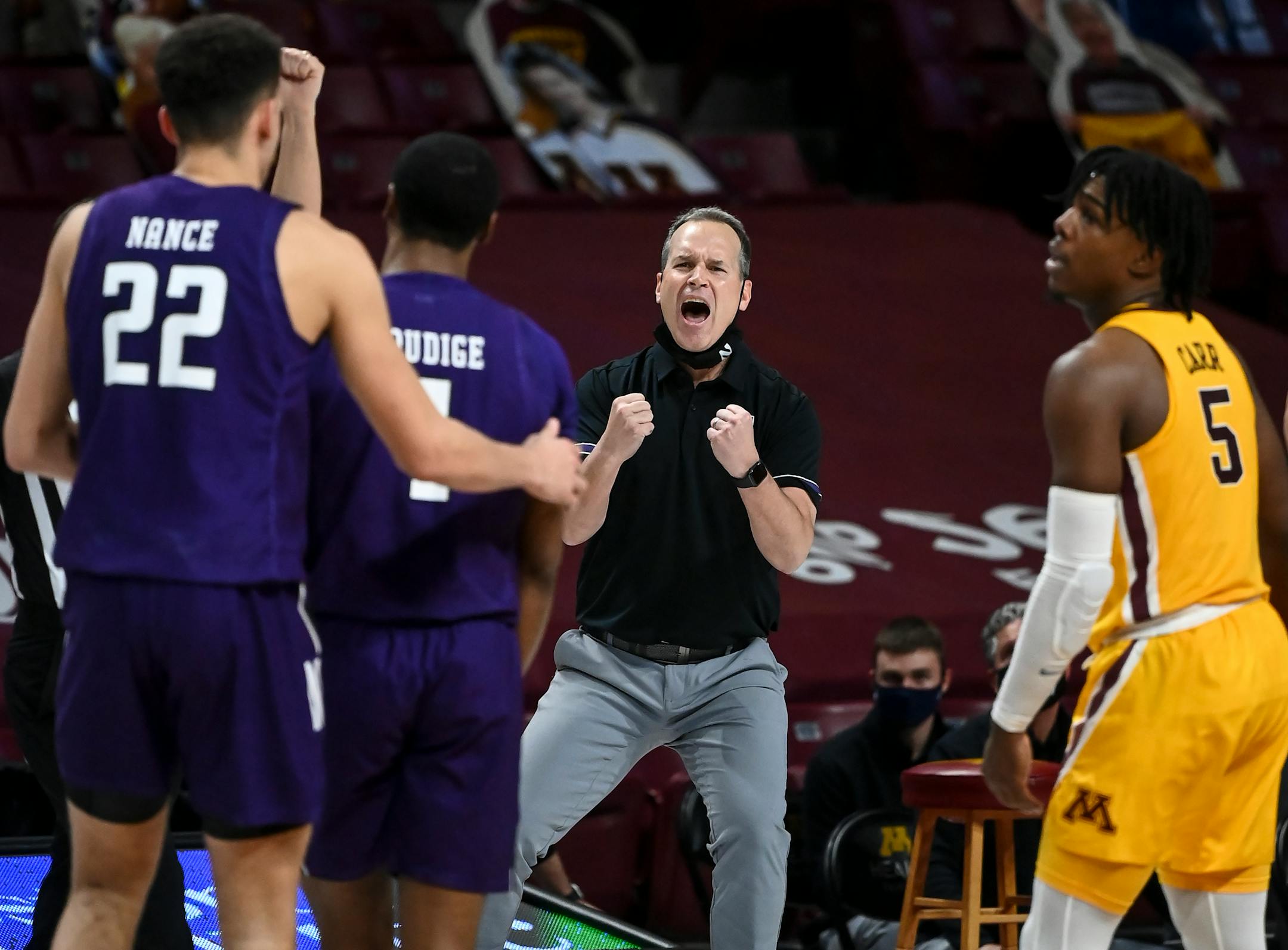 Northwestern Wildcats head coach Chris Collins celebrated late in the second half as his team extended their lead against Minnesota.