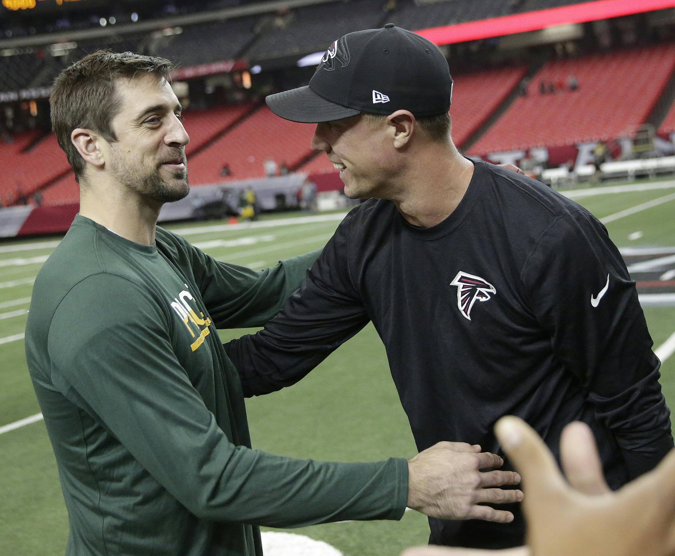 Green Bay Packers quarterback Aaron Rodgers, left, speaks with Atlanta Falcons quarterback Matt Ryan before the first of an NFL football game, Sunday, Oct. 30, 2016, in Atlanta. (AP Photo/David Goldman) ORG XMIT: GAMS1