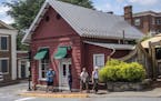 People walk past the Red Hen restaurant in Lexington, Va., Wednesday, June 27, 2018. The co-owner of the Virginia restaurant that refused to serve Whi