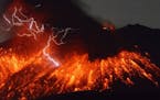 Lightning flashes above flowing lava as Sakurajima, a well-known volcano, erupts Friday evening in southern Japan. Japan's Meteorological Agency said 