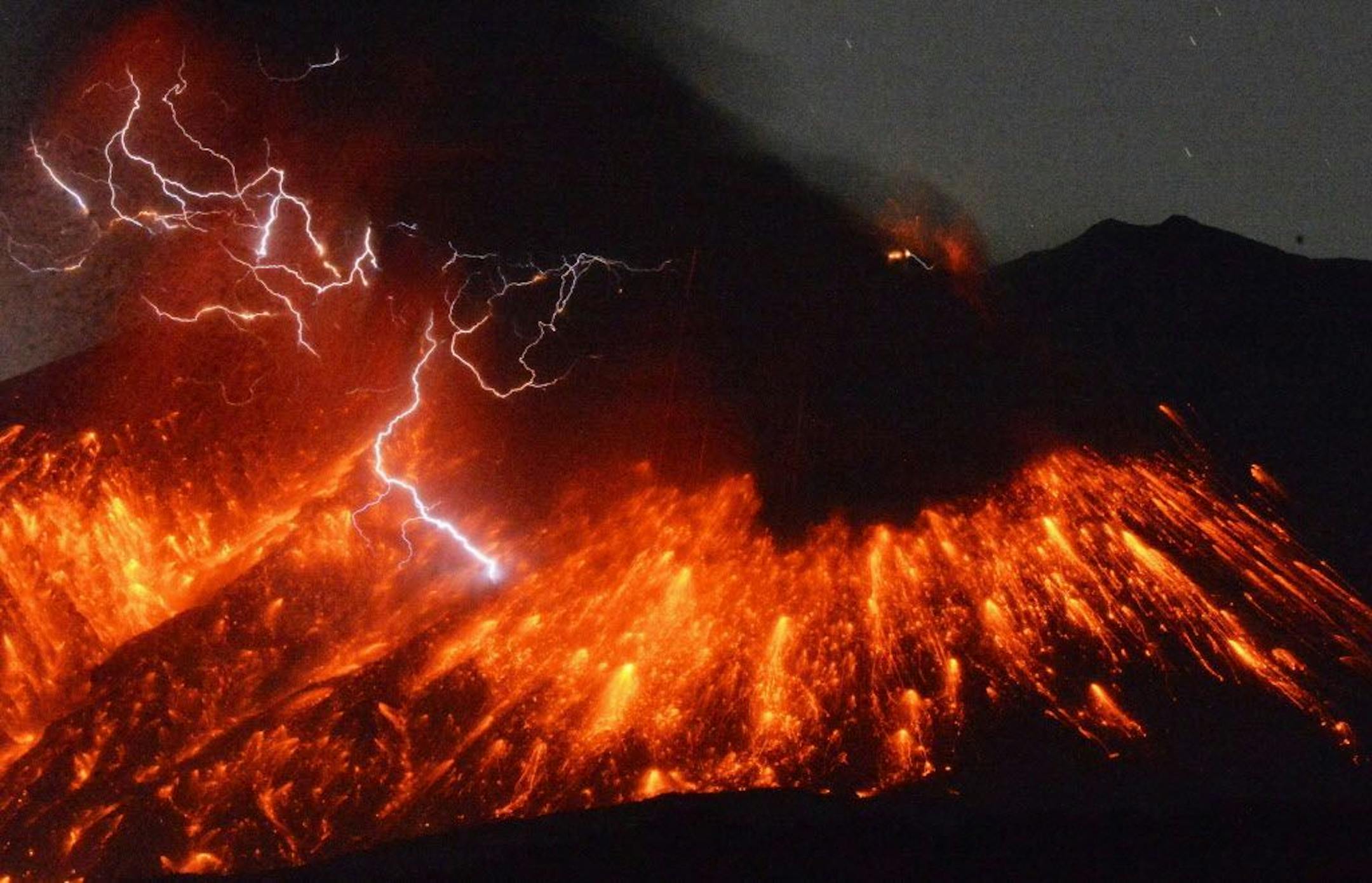 Lightning flashes above flowing lava as Sakurajima, a well-known volcano, erupts Friday evening in southern Japan. Japan's Meteorological Agency said Sakurajima on the island of Kyushu erupted at around 7 p.m. (1000 GMT). (Kyodo News via AP) JAPAN OUT, CREDIT MANDATORY