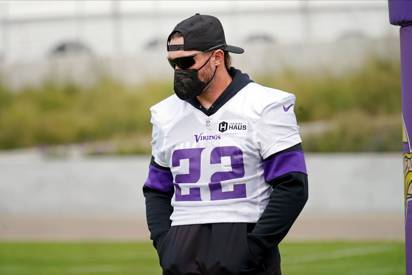 Minnesota Vikings free safety Harrison Smith (22) stands in the end zone wearing a medical face mask required by the team for unvaccinated players during the NFL football team's training camp, Thursday, Aug. 5, 2021, in Eagan, Minn. (AP Photo/Jim Mone)