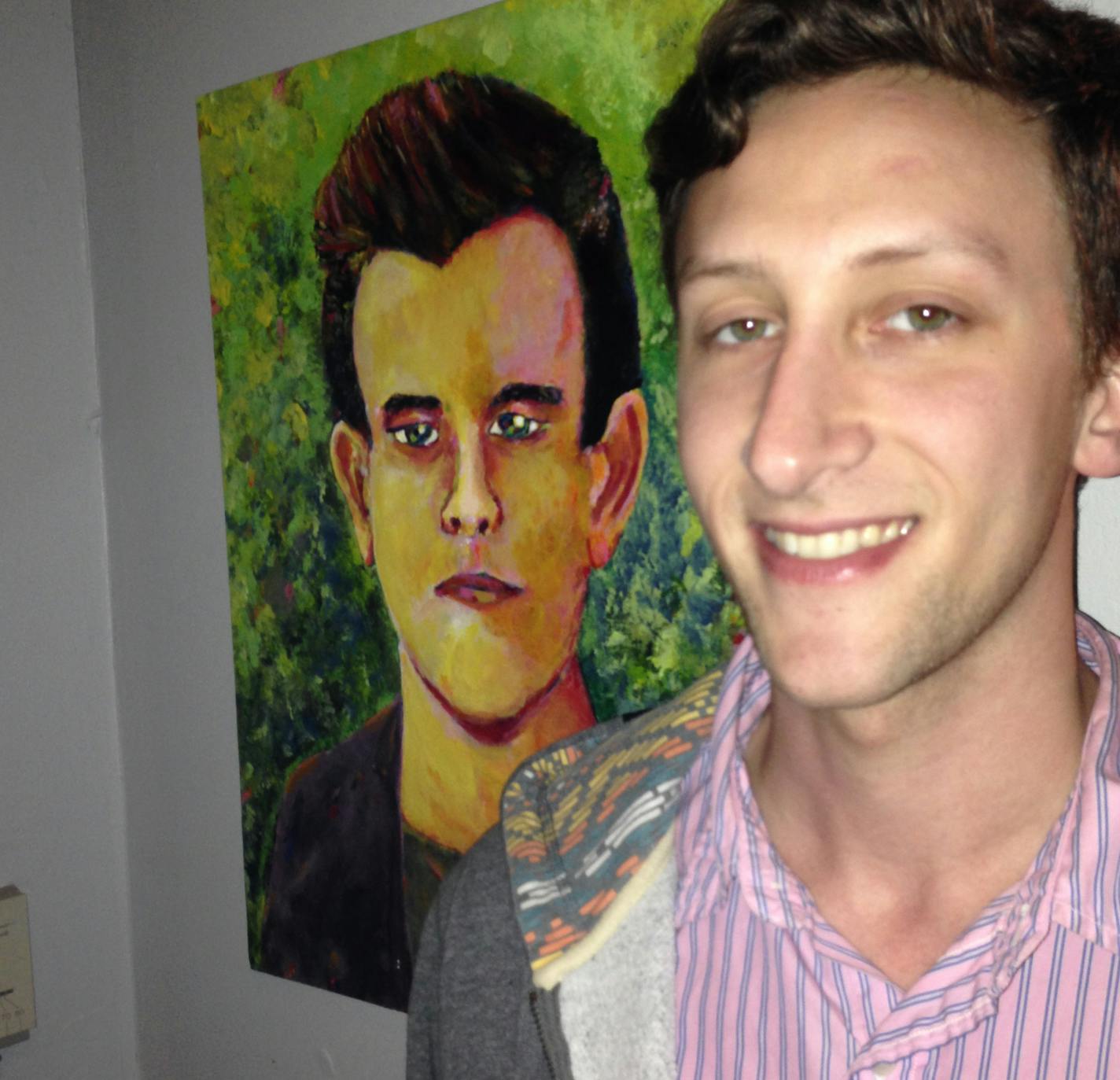 Evan Kale posed with his painting of Connor Franta.