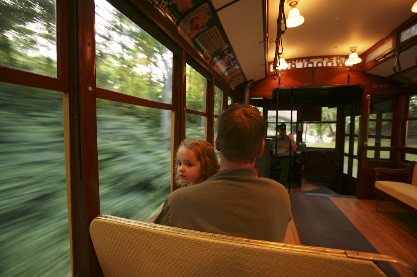 Kira Havel, almost 3, felt the cool breeze from the open windows on the trolly's return trip to Lake Harriet and the Linden Hills Station. She was on the trip with her dad, Matt. They live in Golden Valley.
GENERAL INFORMATION: JEFF WHEELER &#xd4; jwheeler@startribune.com
MINNEAPOLIS - 6/23/06 - It's summer and that means trying to find ways to entertain youngsters. The Como - Harriet Streetcar Line, which has run between Lake Harriet and Lake Calhoun since 1971, is always a safe bet. Trolley ri