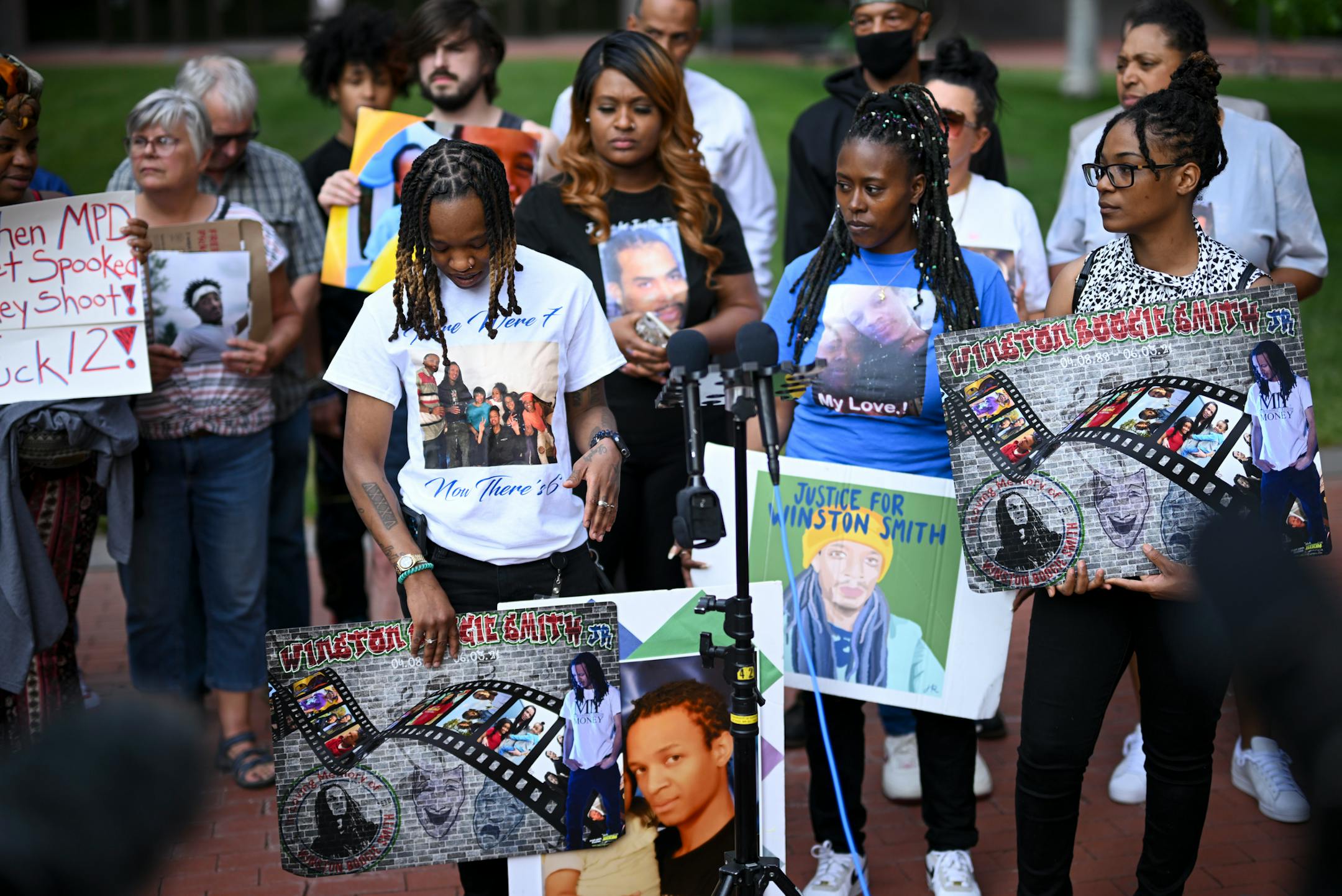 Shatana Cooper, left, of center, held a photo of her brother Winston Smith beside family members at a rally outside the Hennepin County Government Center Friday, June 16, 2023, in Minneapolis, Minn. Smith was shot and killed in an Uptown parking lot in 2021 by a federal fask force that included Minneapolis Police and Hennepin County Sheriffs. The US Department of Justice released the findings in its sweeping investigation into the Minneapolis Police Department finding it routinely engaged in a pattern of racist and abusive behavior.