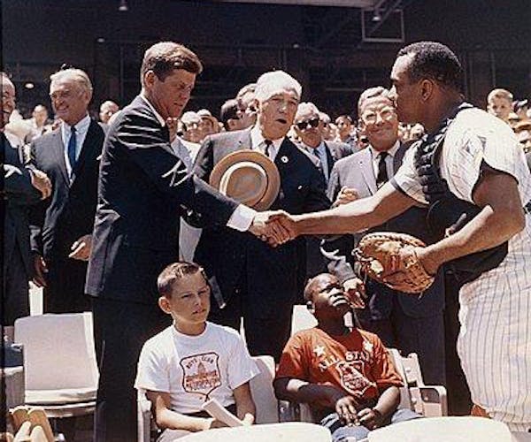 John F. Kennedy shakes hand with Twins catcher, Earl Battey