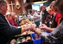 Bonnie Randall, director of Manna Market led the group of volunteers in prayer before handing out food for the last time. ] GLEN STUBBE * gstubbe@star