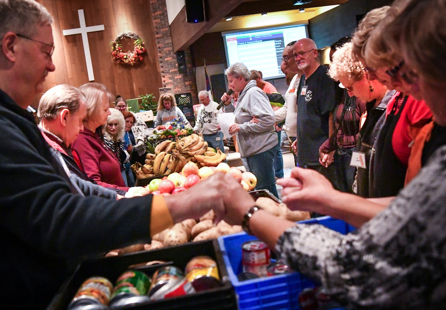 Bonnie Randall, director of Manna Market led the group of volunteers in prayer before handing out food for the last time. ] GLEN STUBBE * gstubbe@startribune.com Friday, October 21, 2016 After 50 years, Good Shepherd Covenant Church in Blaine is closing its doors -- due to dwindling membership and financial issues. Though only 60 worshippers remain, the church's closure is a huge blow to the several hundred residents who depend on its food shelf, Manna Market. The last distribution day is Oct. 2