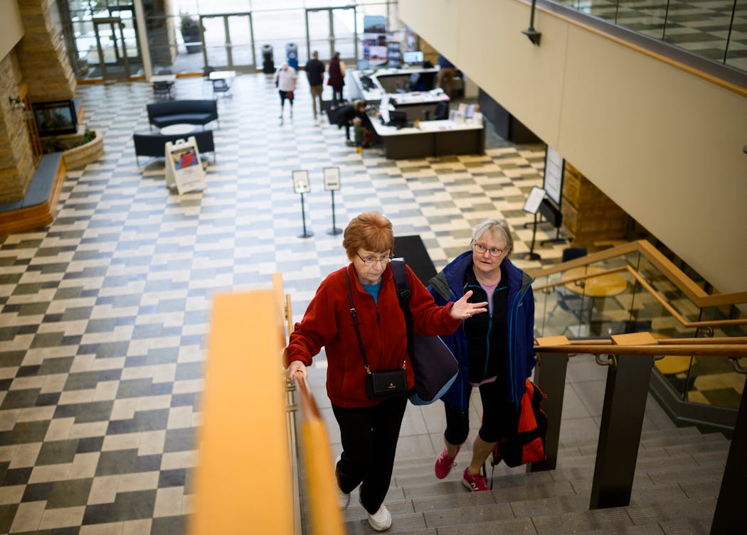 Diane Nieling, right, and Diane Heney walk and talk on their way to the door after finishing playing pickleball on Feb. 23 at the Eagan Community Center.