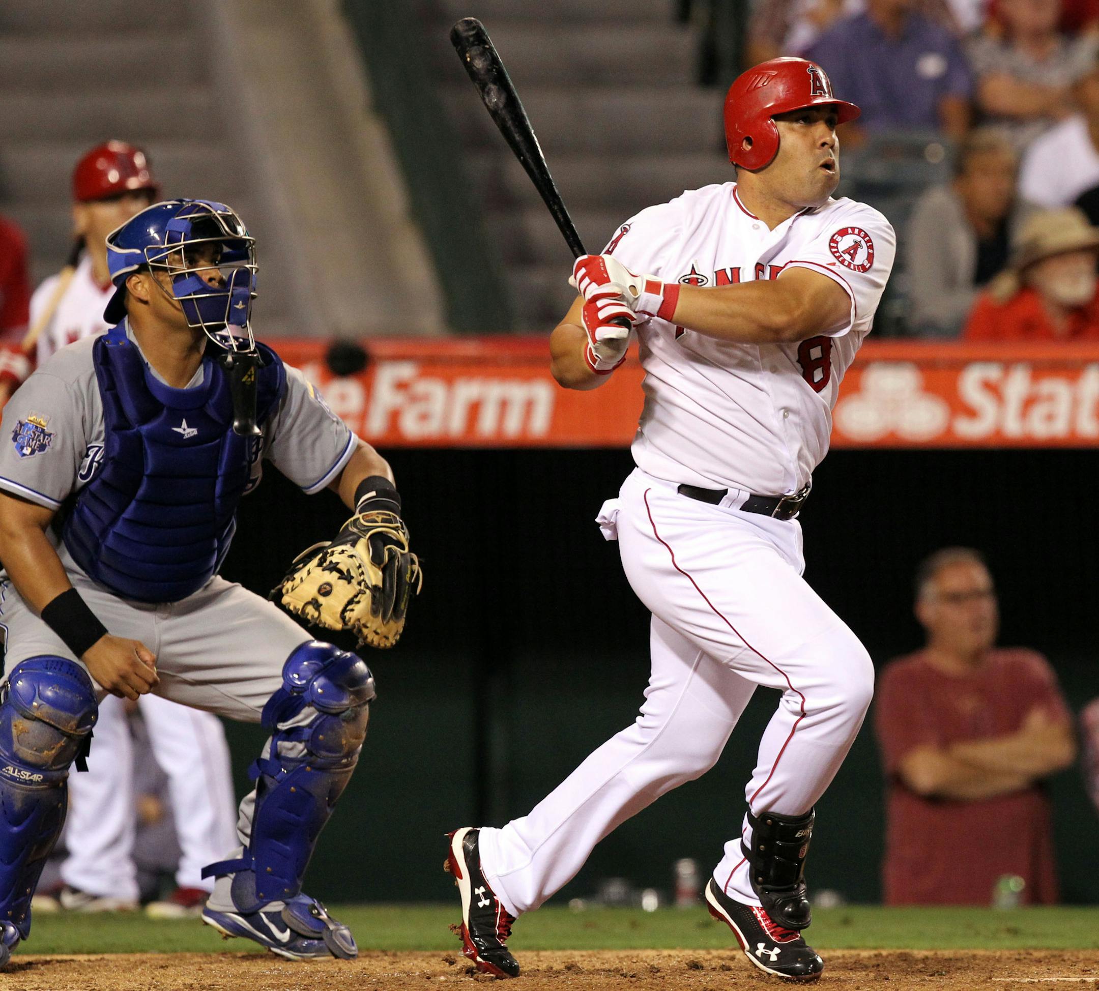 Los Angeles Angels' Kendry Morales and Kansas City Royals catcher Brayan Pena watch Morales' 3-RBI base hit that broke a 3-3 tie in the eighth inning of a baseball game in Anaheim, Calif., Monday, July 23, 2012. (AP Photo/Reed Saxon) ORG XMIT: ANS108