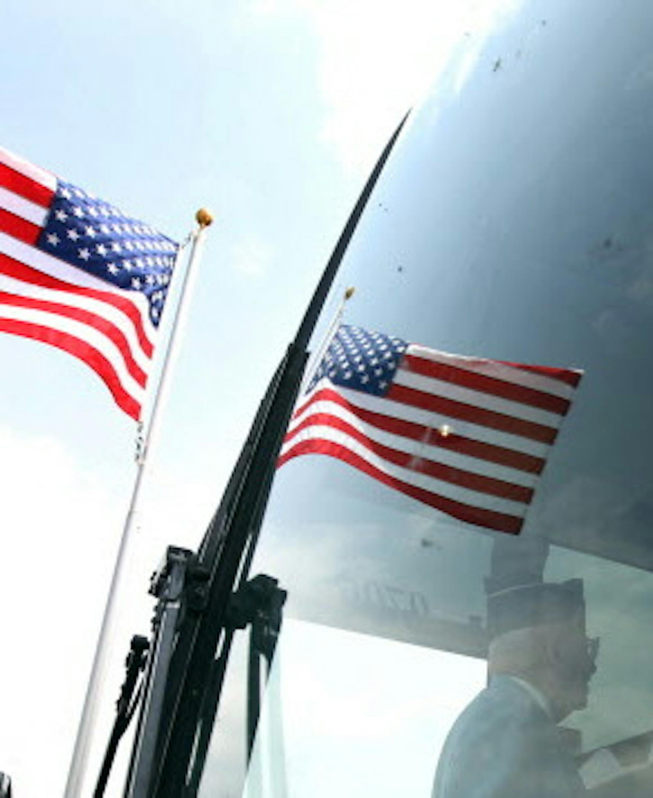 Images of members of the Minnesota Korean War Veterans were reflected in the windshield of a bus as they arrived for the Minnesota State Veterans Cemetery Memorial day program Sunday May 27, 2012 in Little Falls , MN.(Jerry Holt/ STAR TRIBUNE/jgholt@startribune.com) ORG XMIT: MIN2014110812210104