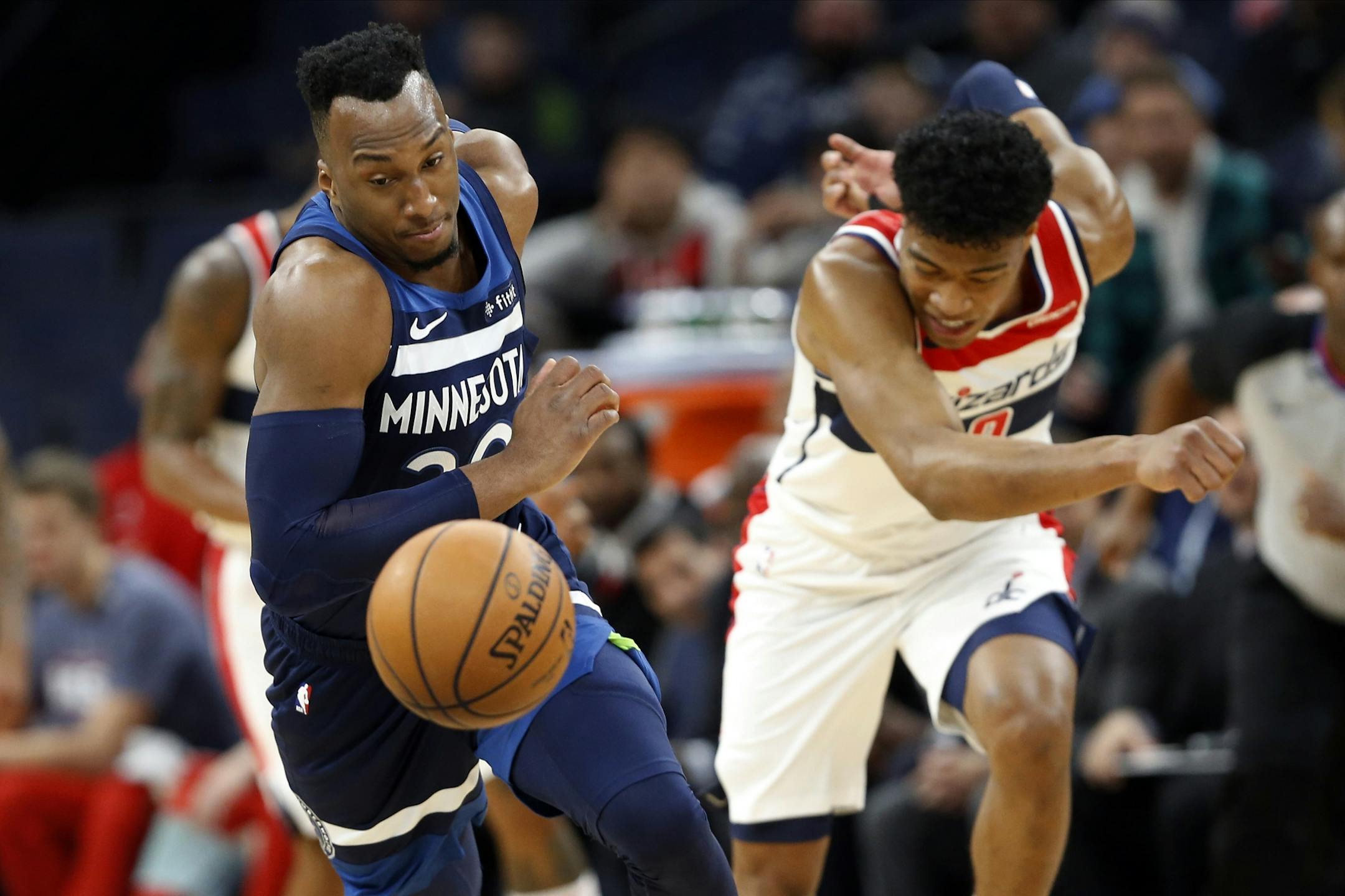 Minnesota Timberwolves' Josh Okogie, left, of Nigeria, beats Washington Wizards' Rui Hachimura, of Japan, to the ball in the first half of an NBA basketball game Friday, Nov 15, 2019, in Minneapolis.