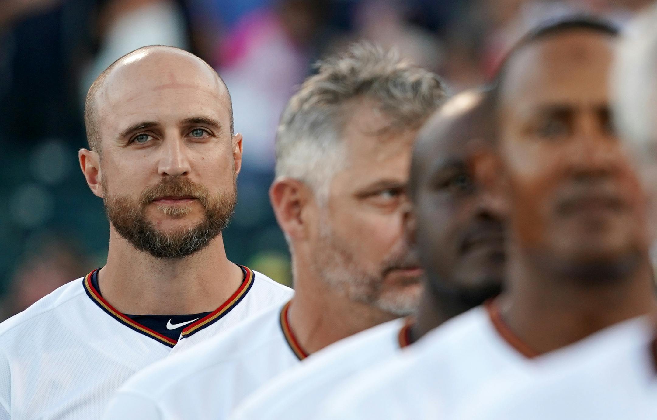 Minnesota Twins manager Rocco Baldelli (5) stood with his fellow coaches during the National Anthem before Saturday's game.
