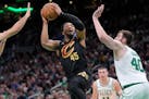 Cleveland Cavaliers guard Donovan Mitchell shoots as Boston Celtics center Luke Kornet defends during the second half of Game 2.