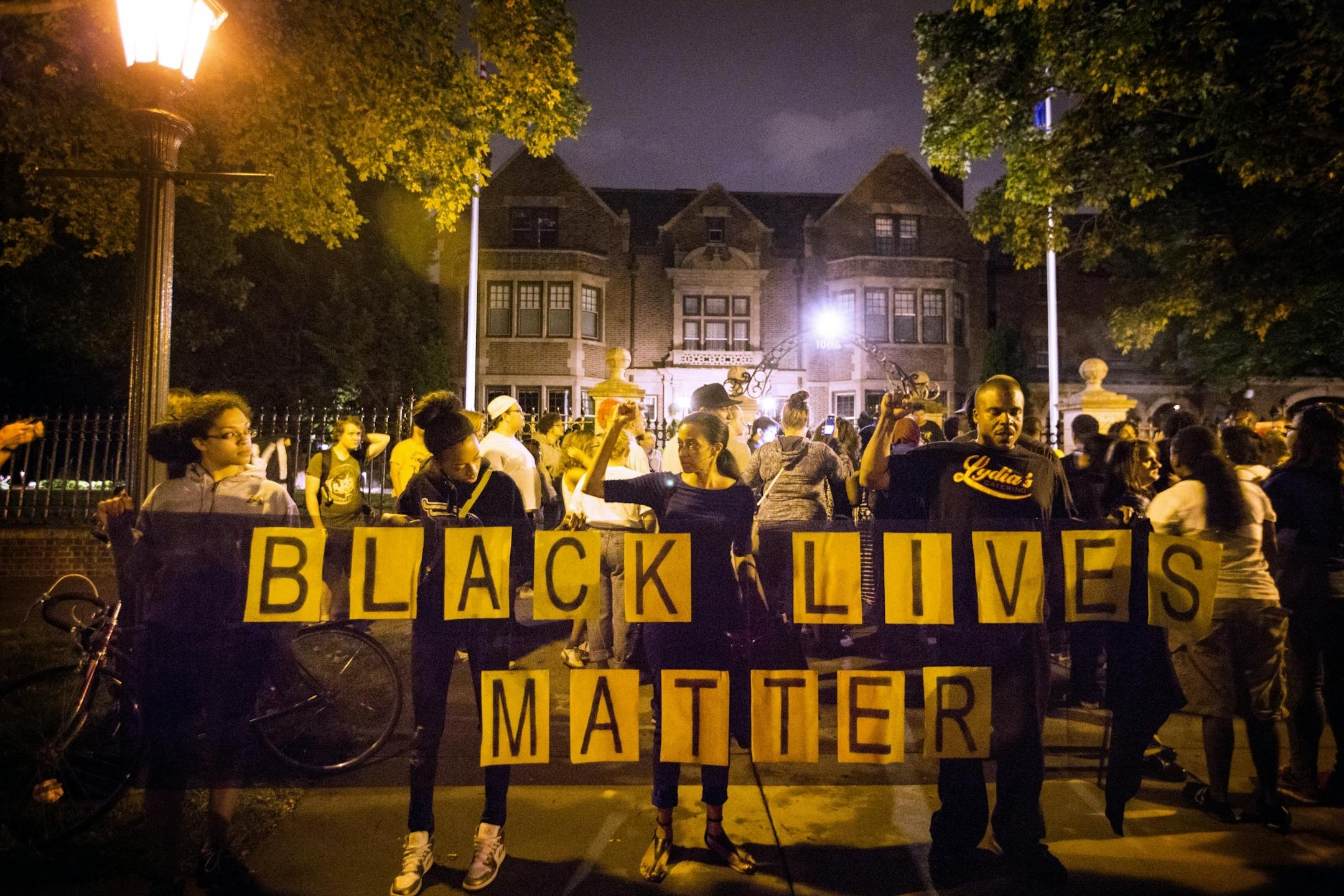 Protesters stand outside the Governor's Mansion on Summit Avenue in St. Paul after the shooting of Philando Castile.