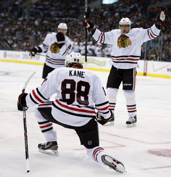 Chicago Blackhawks' Patrick Kane, foreground, celebrates his goal during the first period of an NHL hockey game against the Los Angeles Kings in Los A