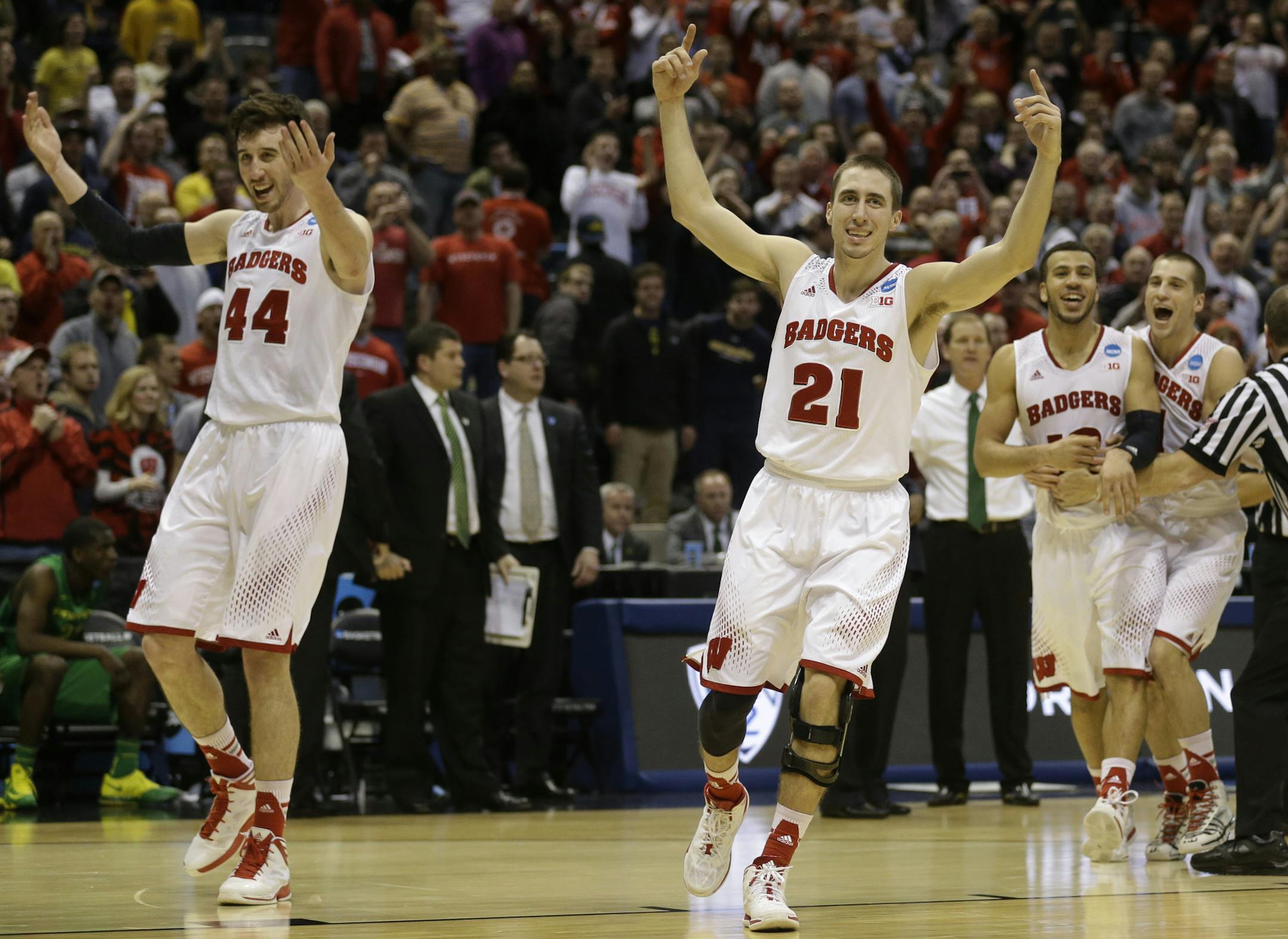 Wisconsin forward Frank Kaminsky (44) and Wisconsin guard Josh Gasser (21) celebrate during the second half of a third-round game against the Oregon in the NCAA college basketball tournament Saturday, March 22, 2014, in Milwaukee. Wisconsin won 82-77. (AP Photo/Jeffrey Phelps)