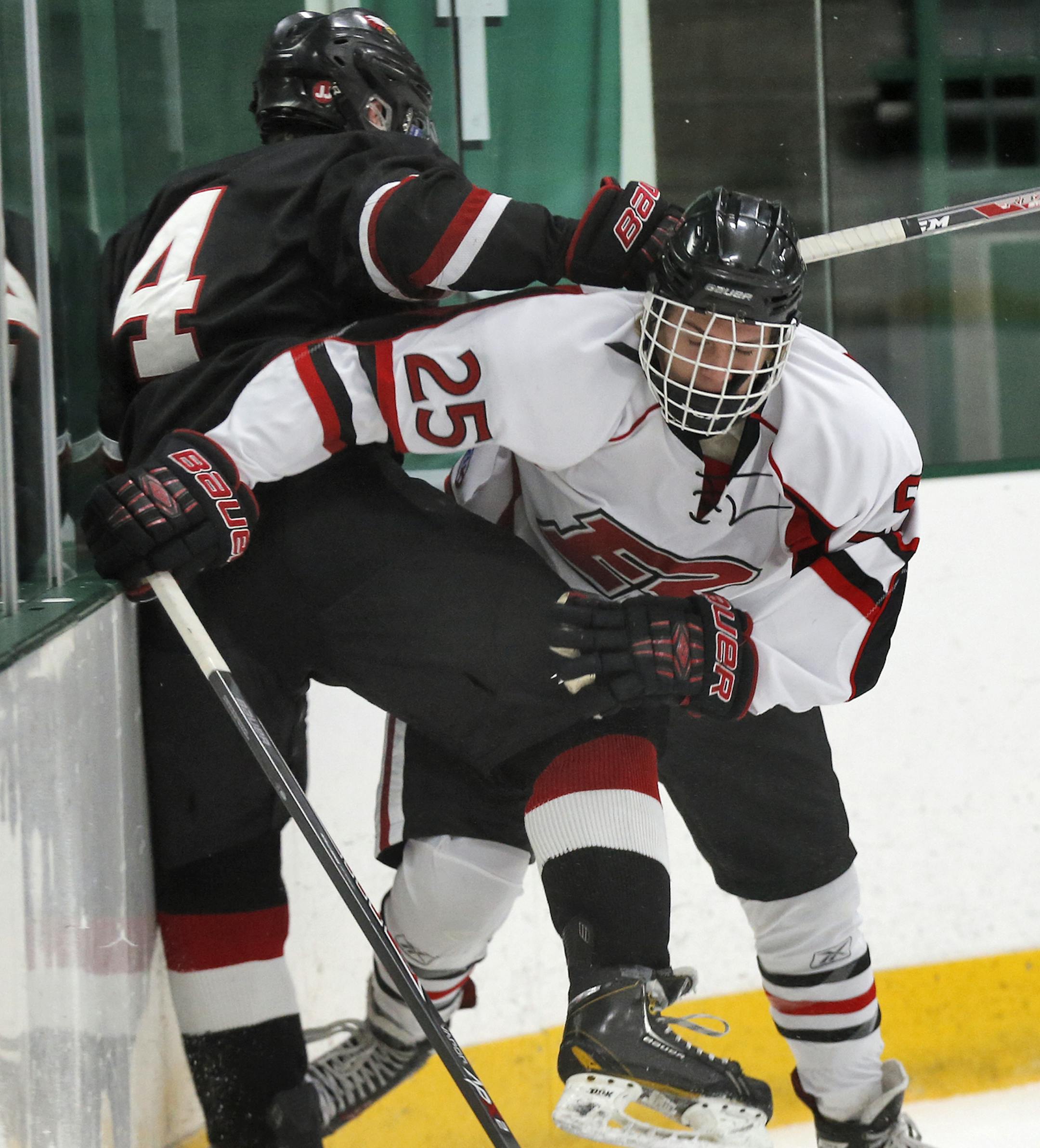 Edina Classic - Eden Prairie vs. Elk River hockey. Eden Prairie's Luc Snuggerud (4) was checked into the boards by Elk River's Alex Schwab (25). (MARLIN LEVISON/STARTRIBUNE(mlevison@startribune.com)