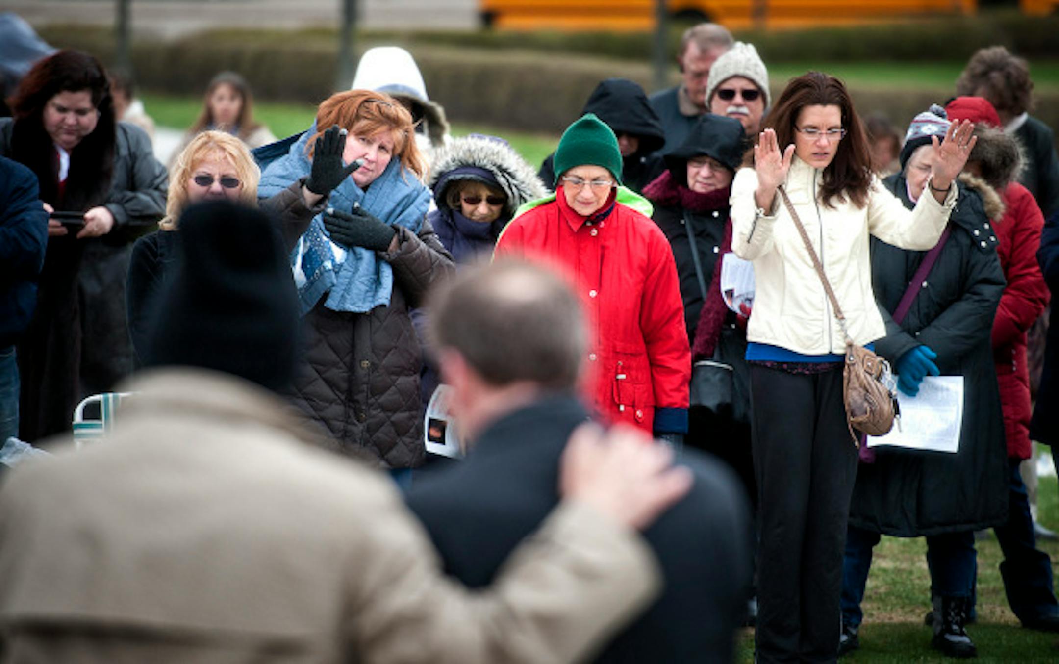 Gary Borgendale, left, put his hand on Secretary of State Mark Ritchie and asked the crowd to pray for him and the state government.  Ritchie read a proclaimation from the governor making today a National Day or Prayer.  At the same time Minnesota Atheists held their Day of Reason inside the Capitol Rotunda, the National Day of Prayer was being celebrated outside the Capitol.  Thursday, May 2, 2013     ]   GLEN STUBBE * gstubbe@startribune.com