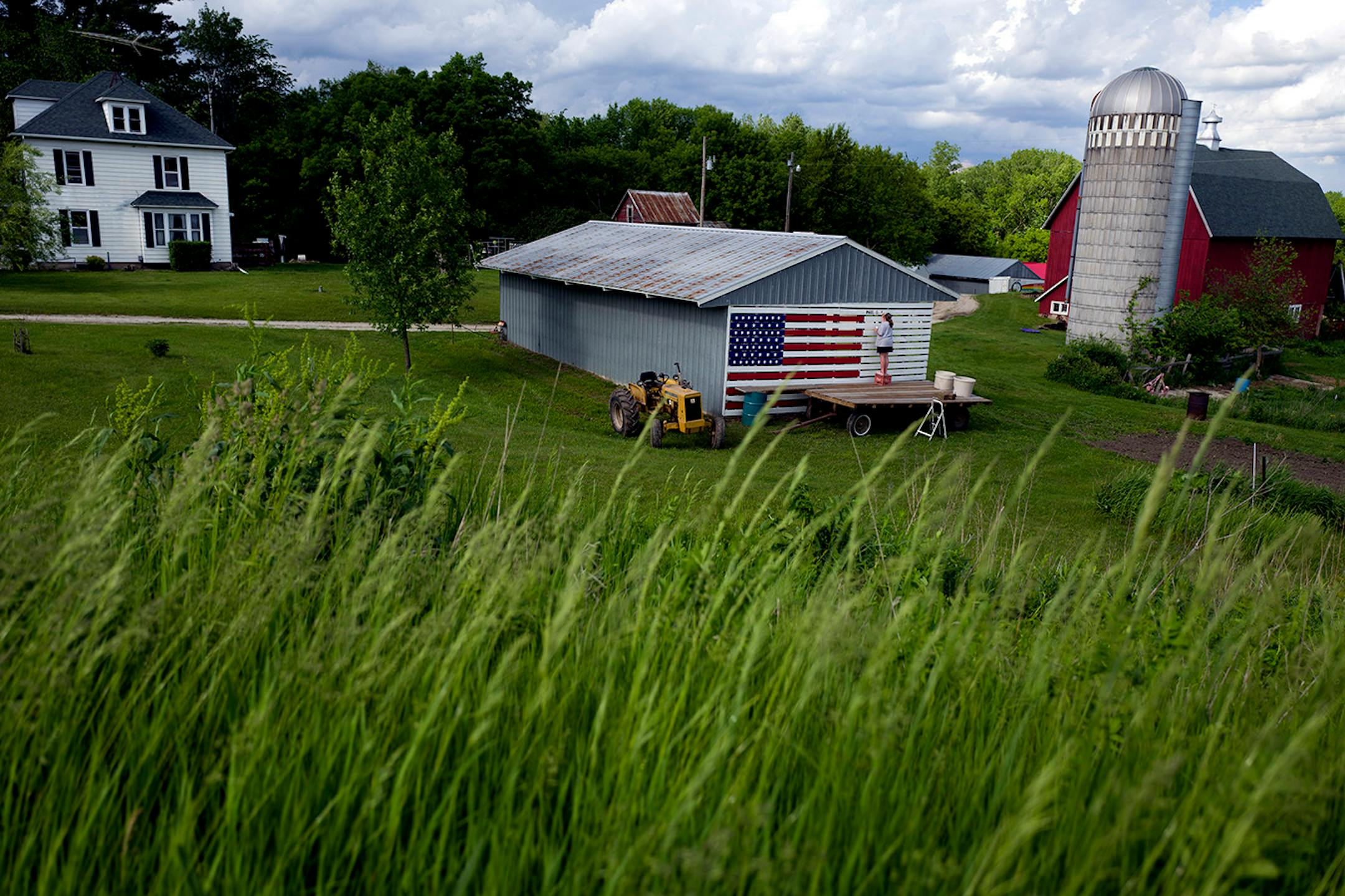 Ann Klindworth painted the names of 15 relatives who have served in the U.S. military on the family barn in their honor for Memorial Day Sunday May 29 2016 in Chatfield, MN.