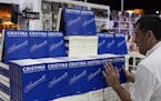 A bookstore employee arranges a display of the new book written by Argentina's former president Cristina Fernandez, at the Buenos Aires book fair, in 
