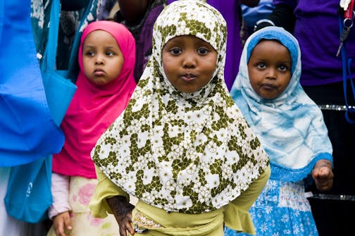 (Left to right) Abeir Abdi,4, Najma Abdi, 2, and Saro Mohamed, 2, all of Minneapolis watch the Somalian music being preformed. Hundreds from the Minneapolis Somalian community gathered on Lake Street on Saturday to celebrate Somali Independence Day which is on July 1.