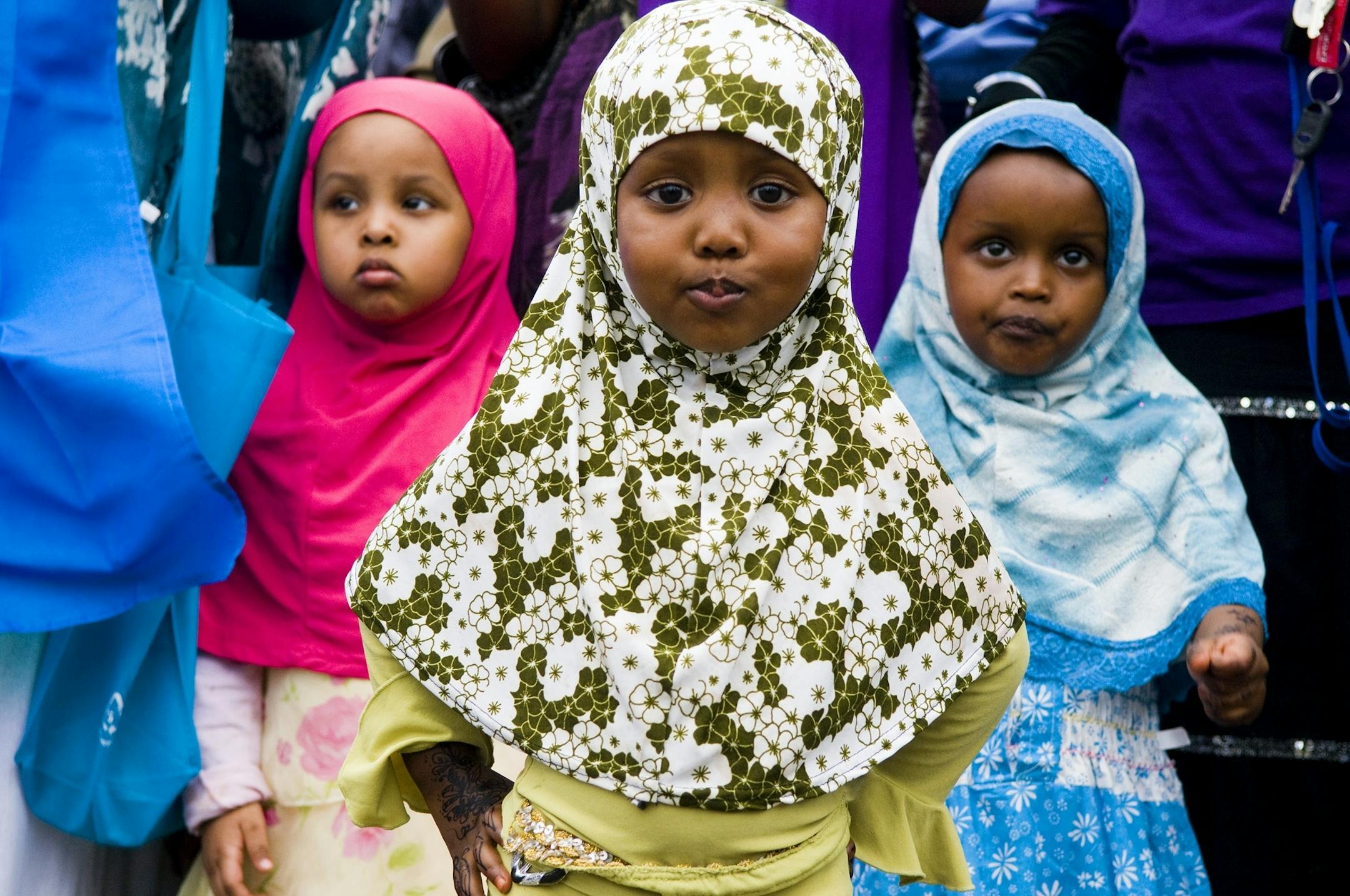 (Left to right) Abeir Abdi,4, Najma Abdi, 2, and Saro Mohamed, 2, all of Minneapolis watch the Somalian music being preformed. Hundreds from the Minneapolis Somalian community gathered on Lake Street on Saturday to celebrate Somali Independence Day which is on July 1.