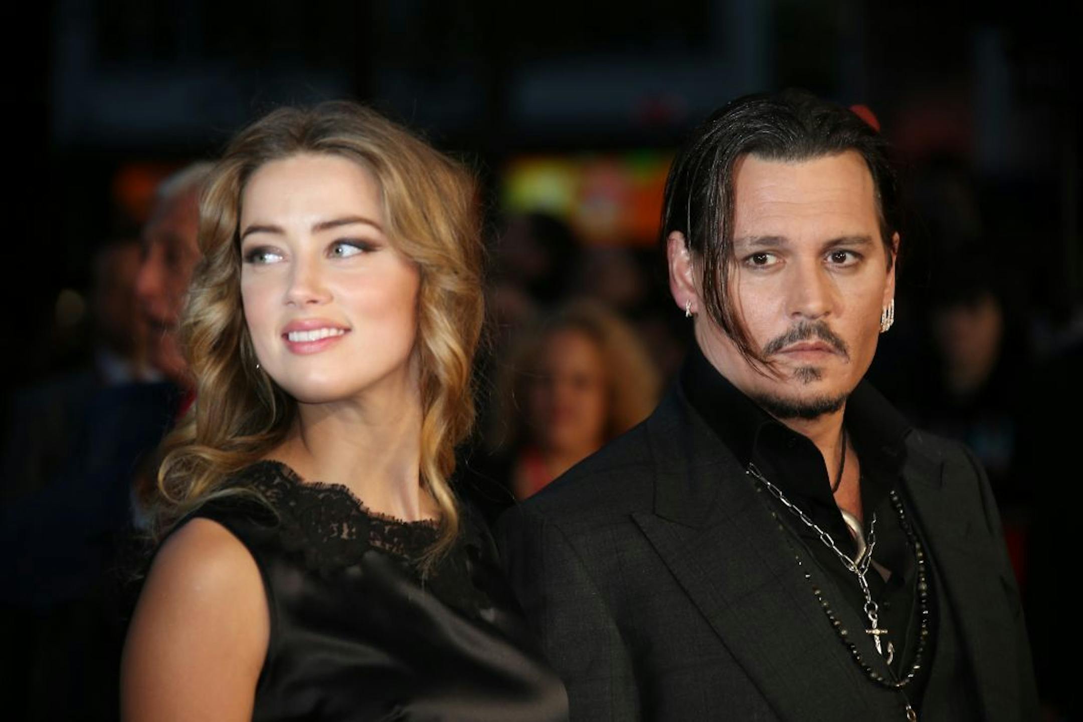 FILE - In this Oct. 11, 2015 file photo, Amber Heard, left, and Johnny Depp arrive at the premiere of Depp's film "Black Mass," at the London film festival. Court records show Heard filed for divorce in Los Angeles Superior Court on Monday, May 23, 2016, citing irreconcilable differences. The pair were married in February 2015 and have no children together.