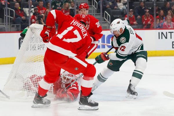 Detroit goaltender Jimmy Howard stops Wild center Eric Staal during the first period, but it was not an overall solid performance as the Wild cruised 