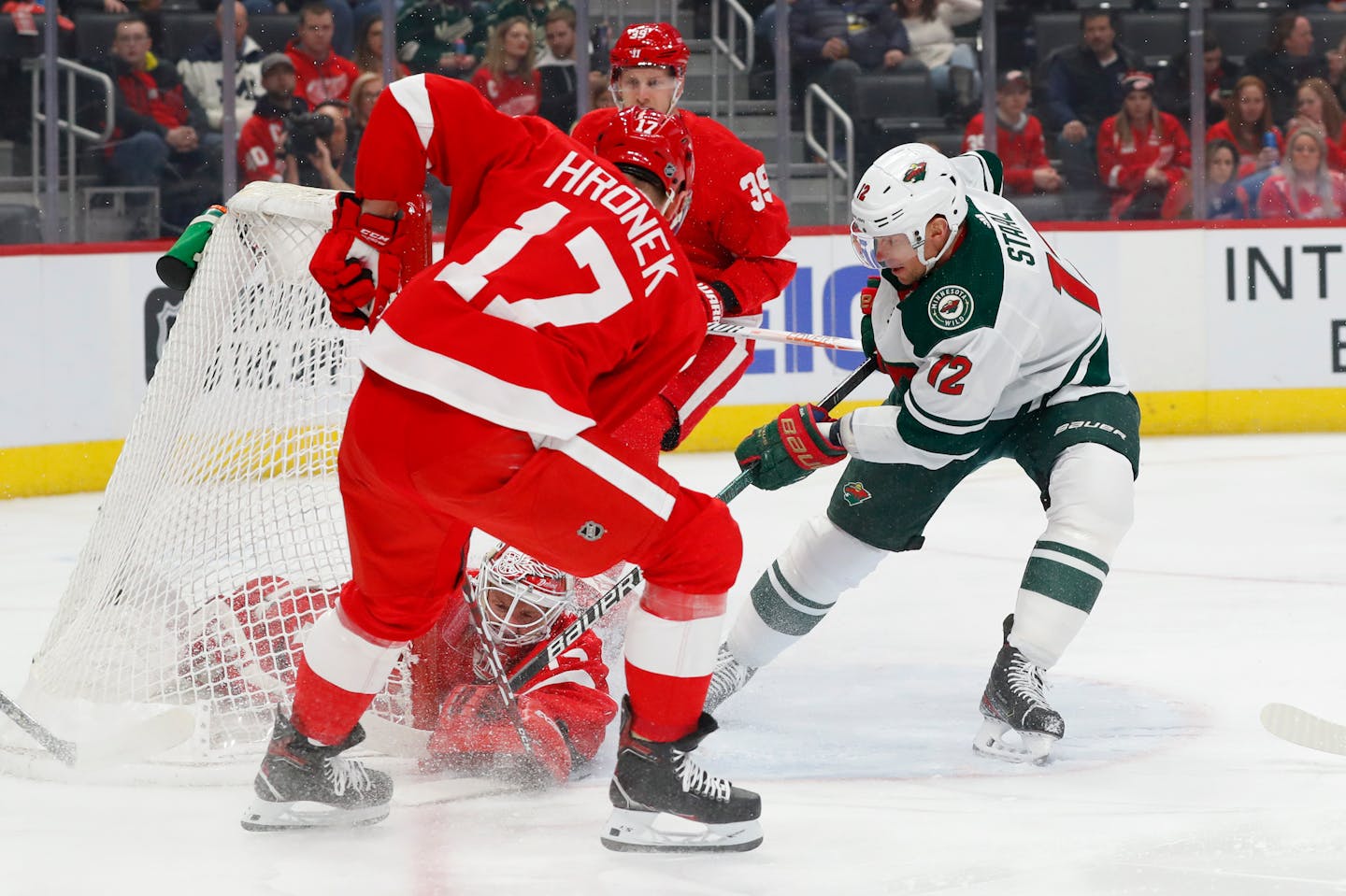 Detroit goaltender Jimmy Howard stops Wild center Eric Staal during the first period, but it was not an overall solid performance as the Wild cruised to a 7-1 victory.