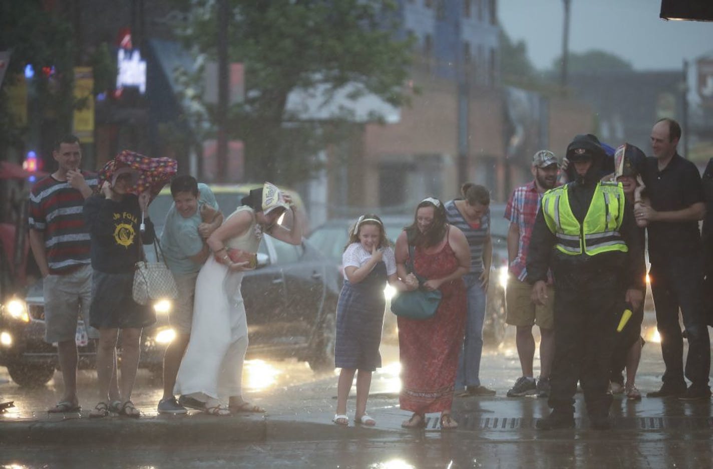 Soggy Adele fans waited to cross the street to get to Xcel Energy Center for her concert Tuesday night.