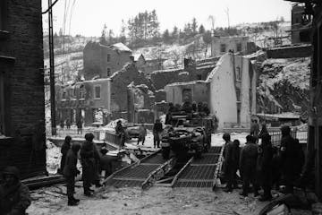 A U.S. Army halftrack crosses pontoons placed by the U.S. Army Corps of Engineers over the Curthe river in Houffalize, Belgium on Jan. 17, 1945. The A