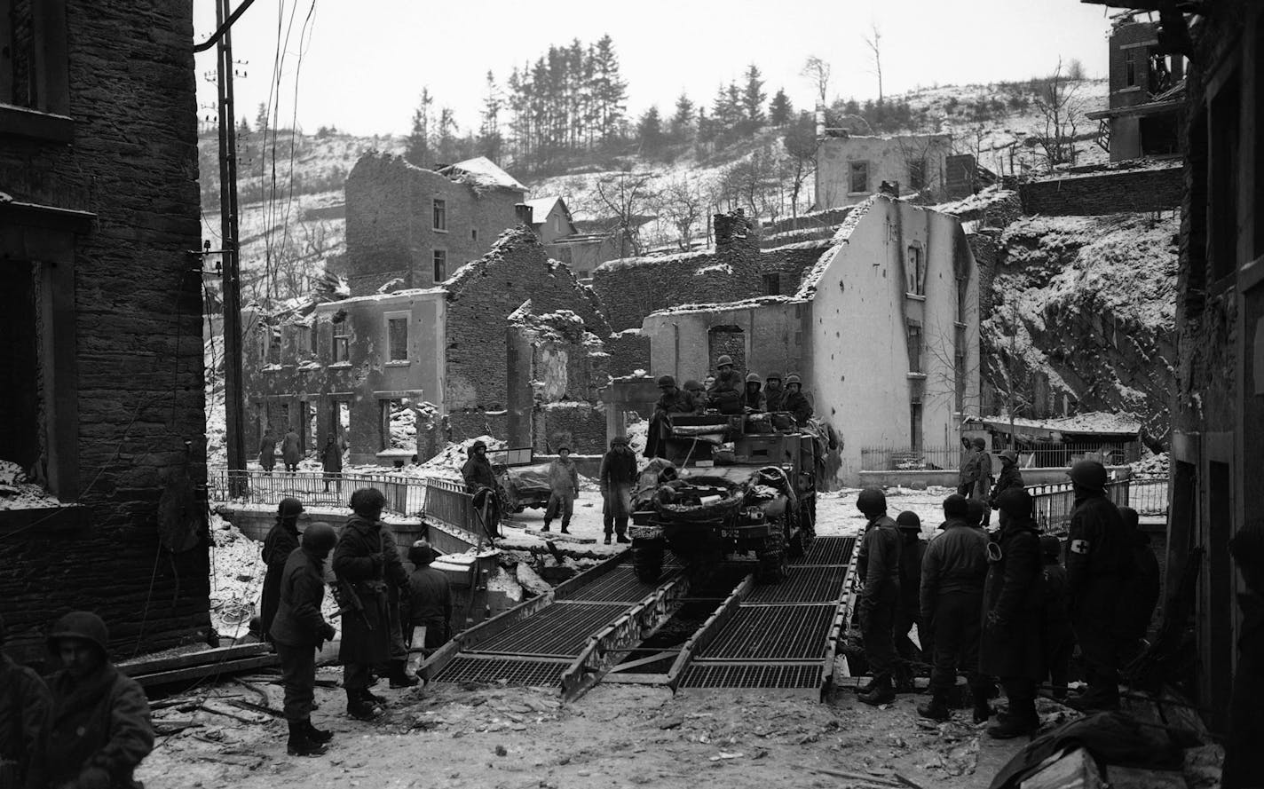 A U.S. Army halftrack crosses pontoons placed by the U.S. Army Corps of Engineers over the Curthe river in Houffalize, Belgium on Jan. 17, 1945. The American First and Third Divisions met in the war-torn town to seal off the breakthrough of the Germans in the Battle of the Bulge. The meeting, exactly a month after the start of the battle, marked its turning point. Several weeks later the 50-mile bulge had been pushed back, and Hitler&#xed;s last desperate attempt to split the Allied forces and w